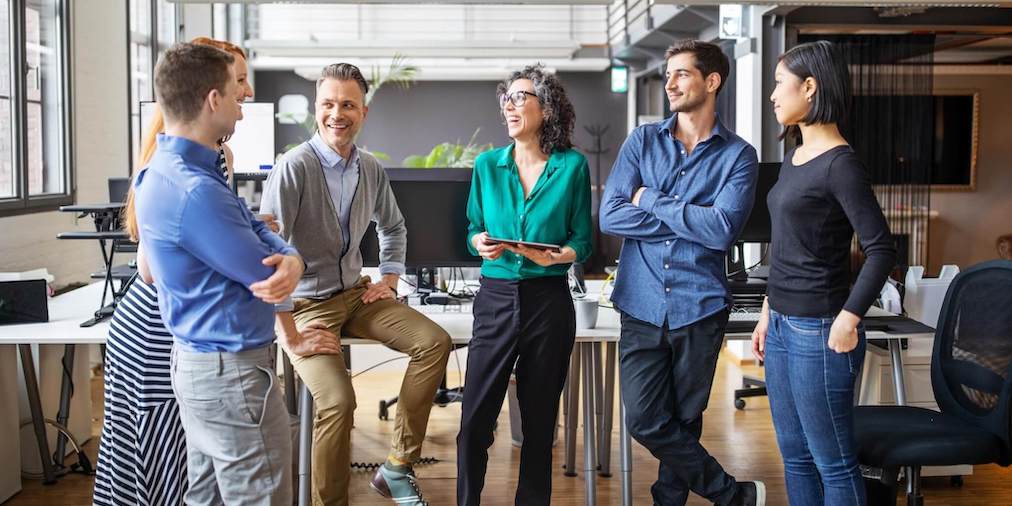 A group of business people standing up in a huddle